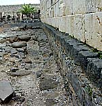 Capernaum synagogue wall with earlier basalt level. Photo copyrighted, BiblePlaces.